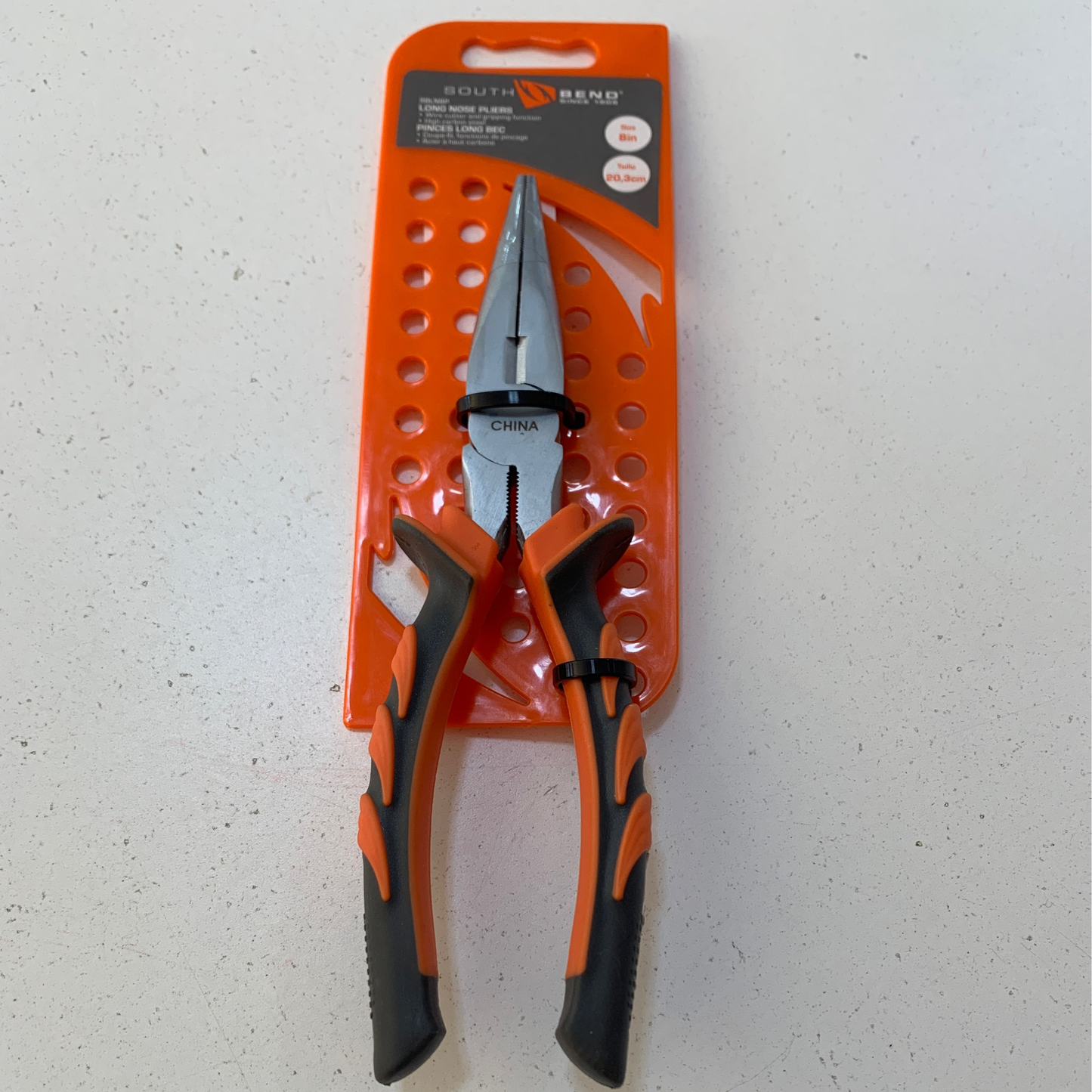 Long nose plier 30249 is orange and black, packaged on an orange perforated card, labeled "China" on the tool, displayed on a white surface.