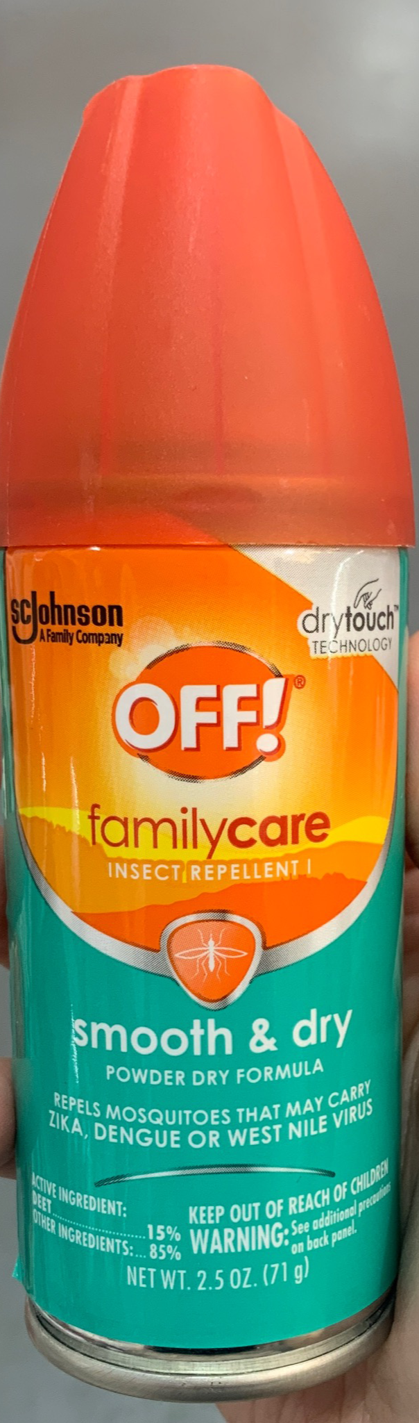 Hand holding a can of Off insect repellent 2.5 oz in a store aisle.