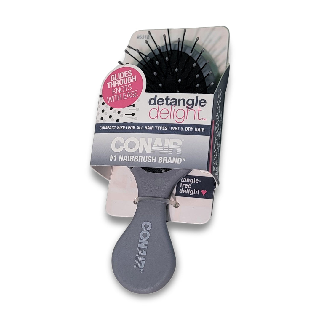 The Conair Detangle Delight hairbrush, in gray packaging, suits all hair types for wet or dry use. This compact travel-size brush is perfect for on-the-go detangling.