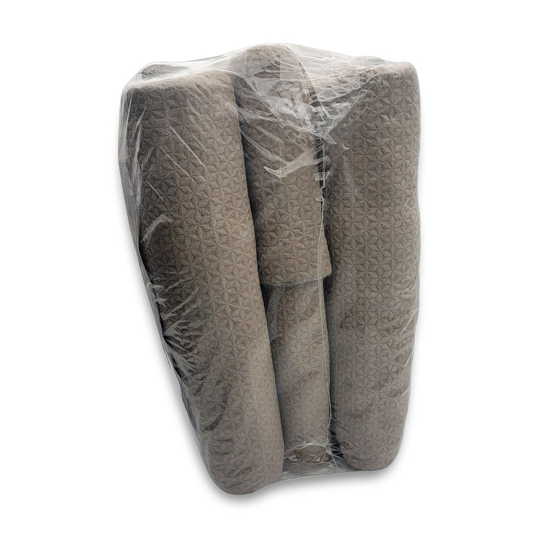 A Luxe pad for securing area rugs is rolled in beige fabric, housed in clear plastic packaging set against a white background.