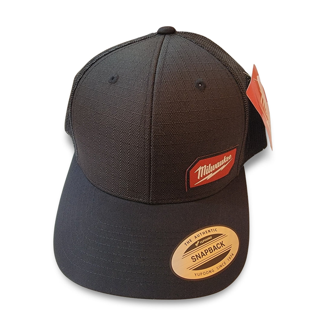 Product Name: Milwaukee Black Snapback Hat Description: Black mesh cap featuring a red Milwaukee logo patch on the front with two tags attached.