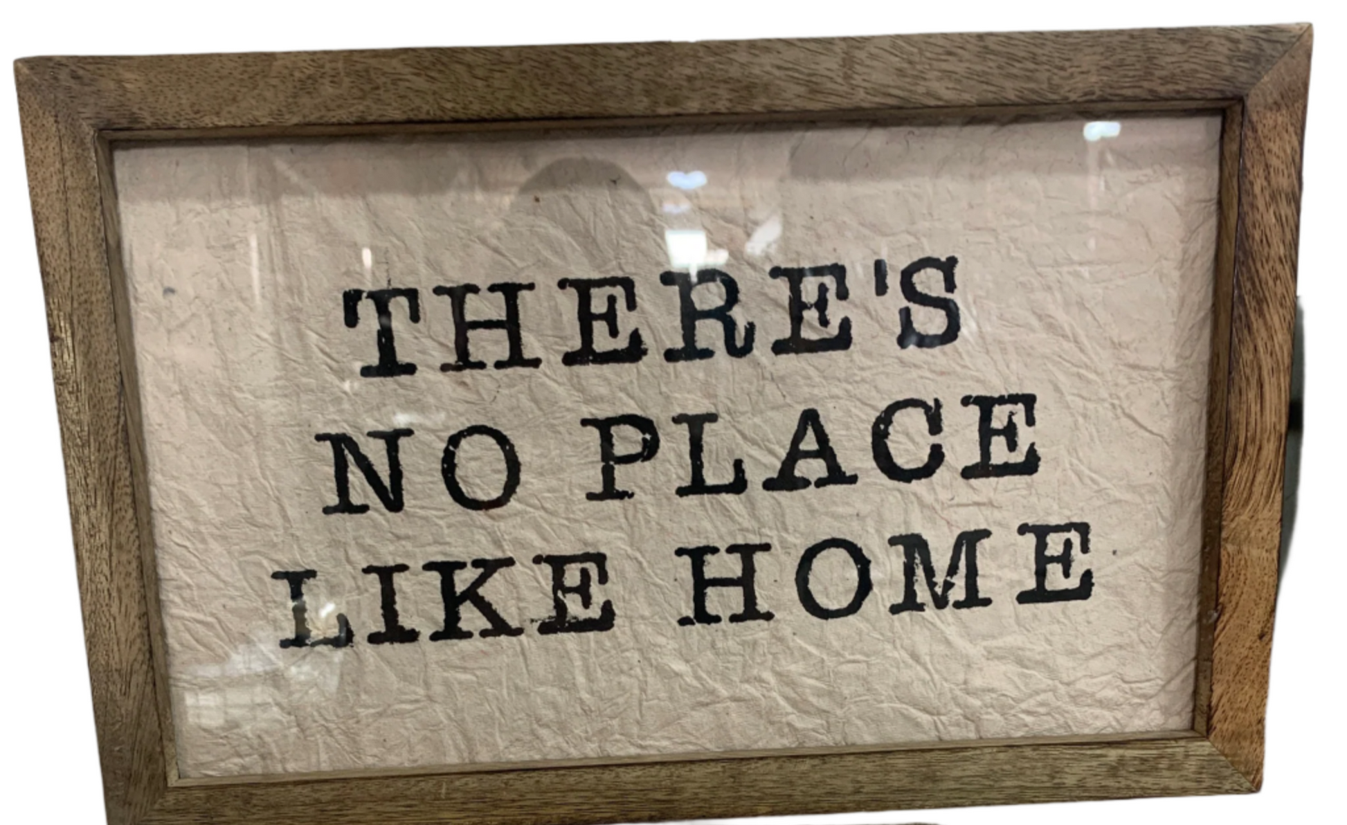 A sign named "There is no place like home" features a wood frame and a textured white background with the phrase "THERE'S NO PLACE LIKE HOME.