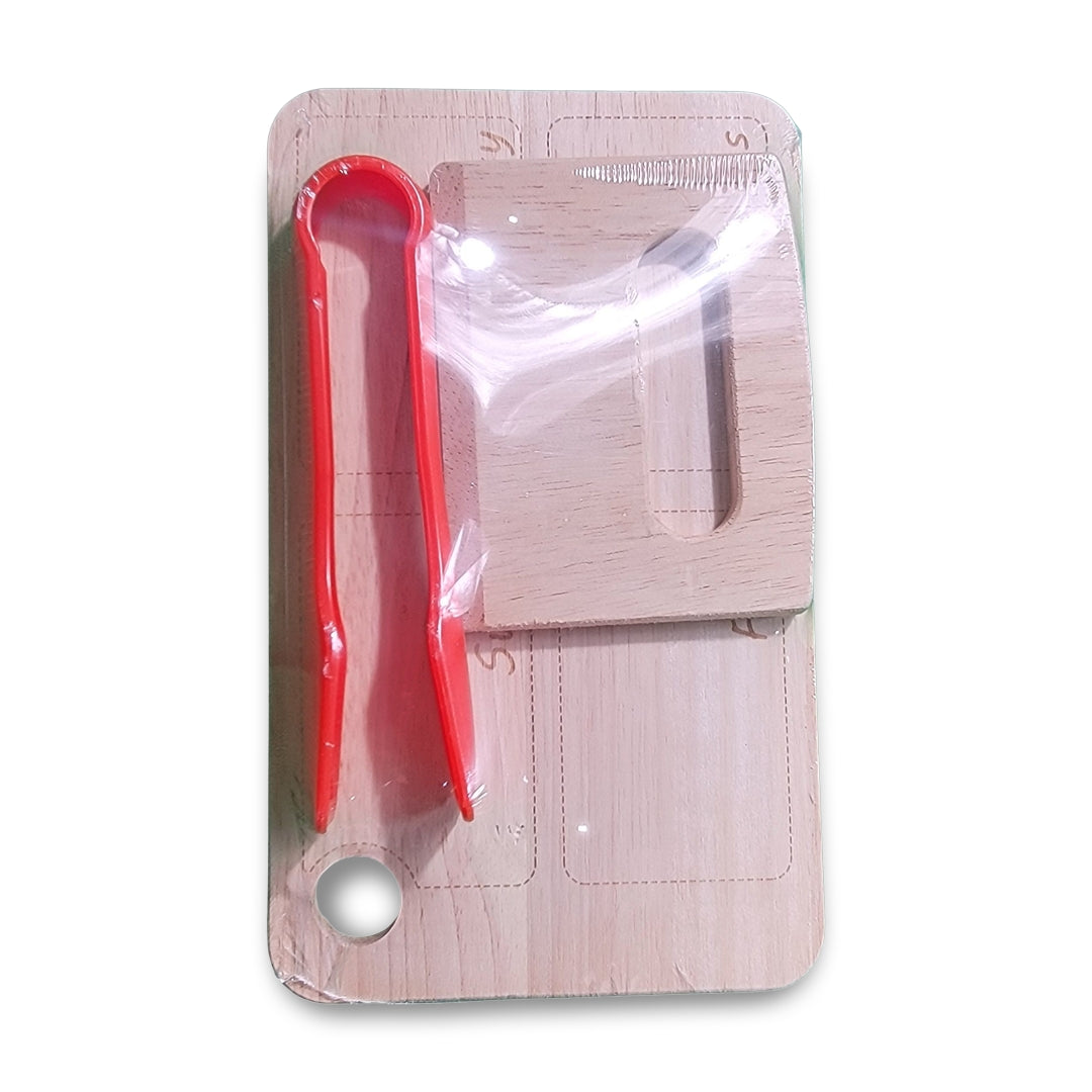 Charcuterie set for kids 4+ including a wooden cutting board, red plastic garlic cutter, and scraper, all packaged in transparent plastic.