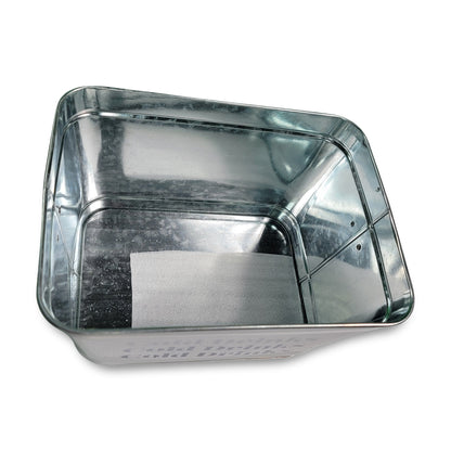 The Cold Drinks Bucket is a rectangular metal container with a reflective surface, featuring an unattached piece of paper lying flat at its bottom.