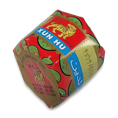 A hexagonal box of Tiger Ointment with a tiger logo, manufactured in 2023, expires in 2028.