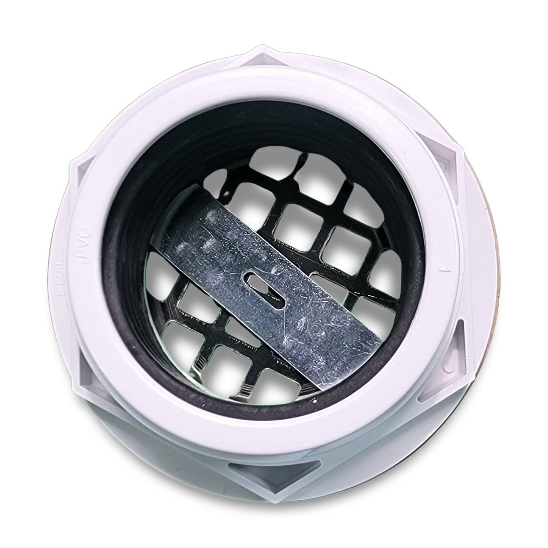 A close-up of the Westbrass d206p-20 PVC Compression shower drain reveals a white plastic drain cover featuring a black grid pattern and a metallic bar across the center.
